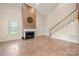 Living room boasts high ceilings, fireplace, tile flooring and staircase at 6218 Indian Trail Fairview Rd, Indian Trail, NC 28079