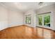 A spacious living room featuring hardwood floors and large windows offering a bright and inviting space at 6218 Indian Trail Fairview Rd, Indian Trail, NC 28079