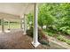 Inviting brick porch with classic white columns and lush landscaping, perfect for relaxing outdoors at 6218 Indian Trail Fairview Rd, Indian Trail, NC 28079
