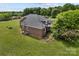 Aerial view of the side of the brick home's backyard and expansive yard space at 6218 Indian Trail Fairview Rd, Indian Trail, NC 28079