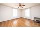 Empty bedroom features wood floors, two windows with curtains and ceiling fan at 625 2Nd Ne St, Hickory, NC 28601
