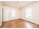 Bright bedroom with two windows, wood floor, ceiling fan, and white trim at 625 2Nd Ne St, Hickory, NC 28601