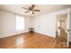 Light-filled bedroom featuring hardwood floors, a ceiling fan, and a doorway at 625 2Nd Ne St, Hickory, NC 28601