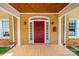 Covered front porch featuring a red door, white columns, and tiled flooring at 625 2Nd Ne St, Hickory, NC 28601