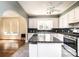 Kitchen with white cabinetry, stone countertops, and an island with additional storage at 625 2Nd Ne St, Hickory, NC 28601