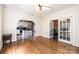 Living room featuring gleaming hardwood floors, a decorative fireplace, and french doors leading to another room at 625 2Nd Ne St, Hickory, NC 28601