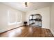 Open floor plan featuring gleaming hardwood floors, large windows, and an arched doorway to the kitchen at 625 2Nd Ne St, Hickory, NC 28601