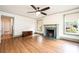 This living room has hardwood floors, a fireplace with a green marble surround, and natural light at 625 2Nd Ne St, Hickory, NC 28601