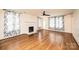 Cozy living room featuring a decorative fireplace, hardwood floors, and lots of natural light at 625 2Nd Ne St, Hickory, NC 28601