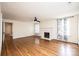 Spacious living room featuring a decorative fireplace, hardwood floors, and lots of natural light at 625 2Nd Ne St, Hickory, NC 28601