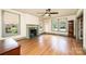 Spacious living room with hardwood floors, a decorative fireplace, and large windows overlooking the street at 625 2Nd Ne St, Hickory, NC 28601