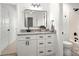 Bathroom vanity with granite countertop, white cabinets, and matte black fixtures for a modern look at 7221 Leaves Ln, Charlotte, NC 28213