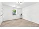 Bedroom with neutral carpet and a window providing natural light, creating a cozy and comfortable space at 7221 Leaves Ln, Charlotte, NC 28213