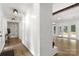 Bright entryway with light wood floors and white brick accent wall leading to an open living space at 7221 Leaves Ln, Charlotte, NC 28213
