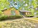 Charming brick home with well-maintained landscaping, lush greenery, and inviting facade at 7221 Leaves Ln, Charlotte, NC 28213