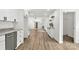 Bright kitchen with white cabinets and stainless steel appliances flows into the living area at 7221 Leaves Ln, Charlotte, NC 28213