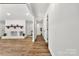 Bright living room with a white painted brick fireplace and wood flooring for a modern and inviting space at 7221 Leaves Ln, Charlotte, NC 28213