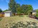 Backyard with a storage shed, large trees, and a pavilion with an outdoor patio underneath at 7325 Forrest Rader Dr, Mint Hill, NC 28227