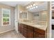 Bathroom features a double sink vanity with granite countertop and large mirror at 7325 Forrest Rader Dr, Mint Hill, NC 28227