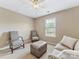 Cozy bedroom featuring neutral walls, plush seating, and a bright window with serene outdoor views at 7325 Forrest Rader Dr, Mint Hill, NC 28227