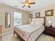 Comfortable bedroom featuring a plaid bedspread, bedside table, and mirror at 7325 Forrest Rader Dr, Mint Hill, NC 28227