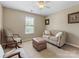 Inviting bedroom with a comfortable sofa, plush ottoman, and neutral decor for a relaxing atmosphere at 7325 Forrest Rader Dr, Mint Hill, NC 28227