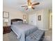 Bedroom boasts a ceiling fan, natural light, neutral carpet, and storage bench at 7325 Forrest Rader Dr, Mint Hill, NC 28227