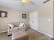 Serene bedroom with neutral walls, stylish sofa, and a cozy ottoman, perfect for relaxation at 7325 Forrest Rader Dr, Mint Hill, NC 28227