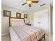 Comfortable bedroom featuring a plaid bedspread, bedside table, and mirrored closet doors at 7325 Forrest Rader Dr, Mint Hill, NC 28227