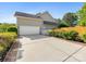 Two-car garage with driveway and partial view of backyard and garden at 7325 Forrest Rader Dr, Mint Hill, NC 28227