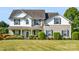 Charming two-story home with well-manicured lawn and landscaping and a mix of siding and architectural details at 7325 Forrest Rader Dr, Mint Hill, NC 28227