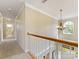 Bright hallway features wood railing, pendant lighting, and natural light from a half-moon window at 7325 Forrest Rader Dr, Mint Hill, NC 28227