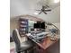 Bright home office with a ceiling fan, custom bookshelves, and a dual-monitor workstation at 7325 Forrest Rader Dr, Mint Hill, NC 28227