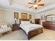This main bedroom includes a ceiling fan, soft carpet, stylish decor, and a bright window at 7325 Forrest Rader Dr, Mint Hill, NC 28227