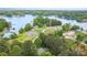 Scenic aerial view of a lake community with houses nestled among trees, offering peaceful waterfront living at 7525 Windy Pine Cir, Denver, NC 28037