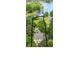 An aerial view of a house with a grey roof surrounded by trees and a lake in the background at 7525 Windy Pine Cir, Denver, NC 28037