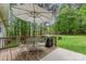 Private back deck with an umbrella, table, chairs, and grill for outdoor gatherings and backyard barbecues at 7525 Windy Pine Cir, Denver, NC 28037