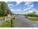 Gated community entrance with lake views, well-maintained landscaping, and secure access for residents at 7525 Windy Pine Cir, Denver, NC 28037