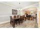 Elegant dining area featuring a wooden table and chairs, with an archway leading to the kitchen at 7525 Windy Pine Cir, Denver, NC 28037