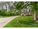 Inviting two-story home with a charming front porch, lush lawn, and mature trees at 7525 Windy Pine Cir, Denver, NC 28037