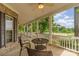 Charming front porch features brick siding, a white railing, and a seating area with furniture at 7525 Windy Pine Cir, Denver, NC 28037