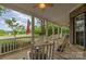 Charming front porch with rocking chairs, white railings, and view of beautifully landscaped front yard and mature trees at 7525 Windy Pine Cir, Denver, NC 28037