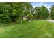 Lush front yard showcasing a well-maintained lawn and mature trees, creating a serene setting at 7525 Windy Pine Cir, Denver, NC 28037