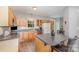Functional kitchen featuring wooden cabinetry, modern appliances, and an island with bar seating at 7525 Windy Pine Cir, Denver, NC 28037