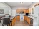 Well-lit kitchen with wooden cabinets, an island with seating, and modern appliances at 7525 Windy Pine Cir, Denver, NC 28037