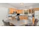 Kitchen with natural wood cabinets, stainless steel appliances, and an island with bar seating at 7525 Windy Pine Cir, Denver, NC 28037