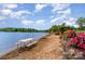 Beautiful lakeside beach area with picnic tables, lush landscaping, and a charming gazebo for relaxing by the water at 7525 Windy Pine Cir, Denver, NC 28037