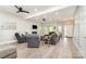 Spacious living room featuring modern flooring, a fireplace, and ample natural light at 7525 Windy Pine Cir, Denver, NC 28037