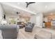 Bright and airy living room with a view of the staircase, dining area, and a glimpse of the kitchen at 7525 Windy Pine Cir, Denver, NC 28037