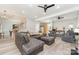 Open-concept living room with a comfortable seating area, hardwood floors, and access to the dining area at 7525 Windy Pine Cir, Denver, NC 28037
